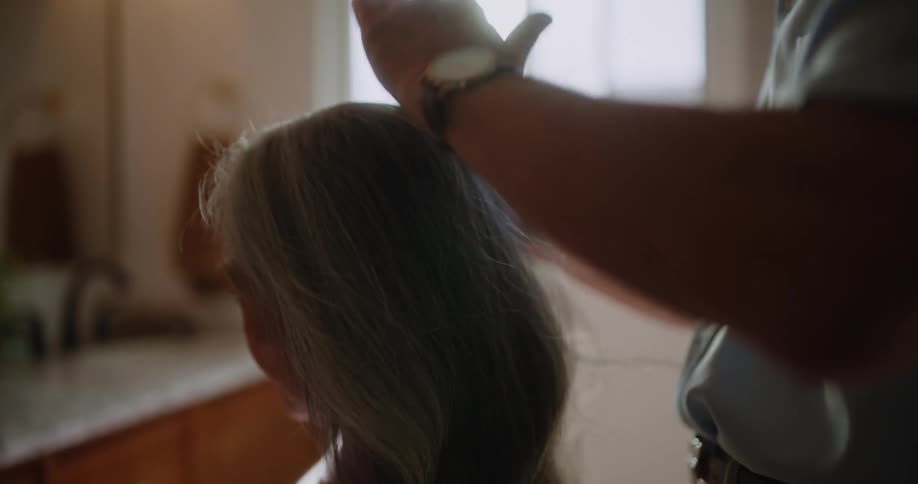 Lord combing his wifes hair and kissing her head