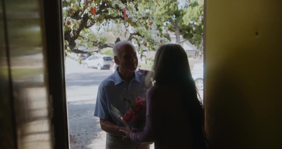 Husband brings flowers to his wife at her house