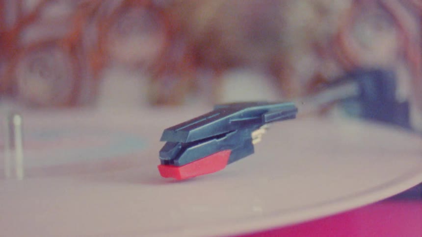 Closeup on a vinyl record on a vintage machine