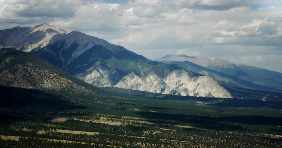 Mountains are covered in snow during a cloudy day