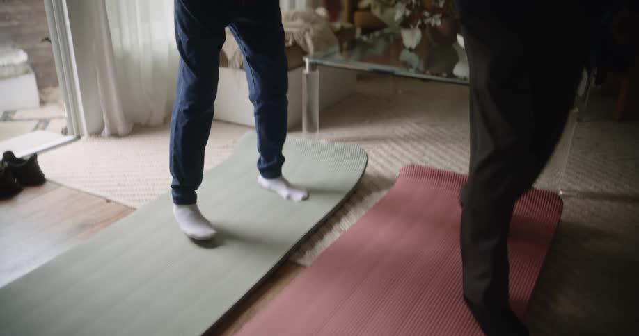 Elderly couple on tatami mats performing dance steps in the living room