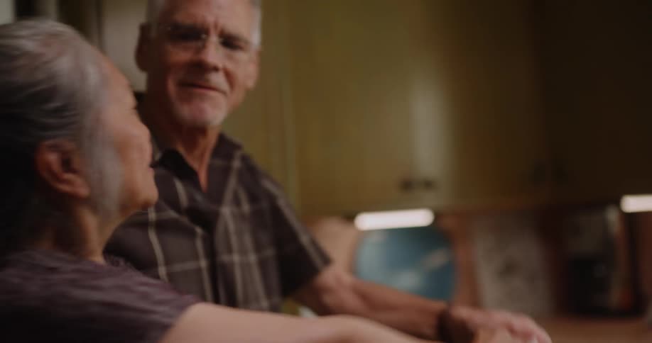 Elderly couple in the kitchen dancing a waltz romantically