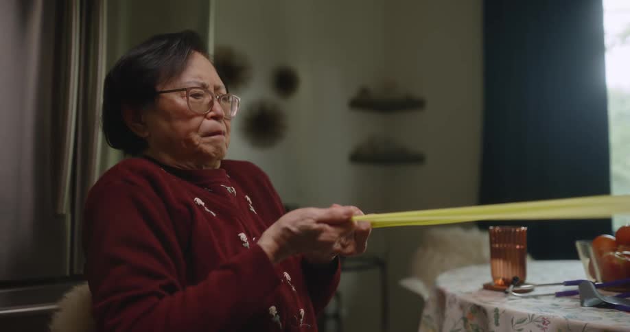 Two people pull a large rubber band in opposite directions
