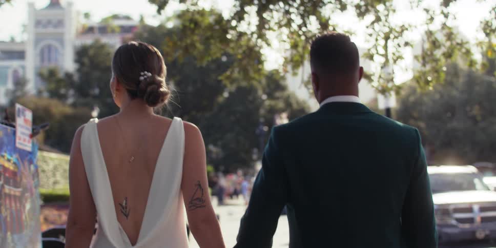 A couple of newlyweds walking on the ciyt streets at morning