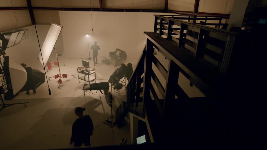 A group of people on a sound stage filming