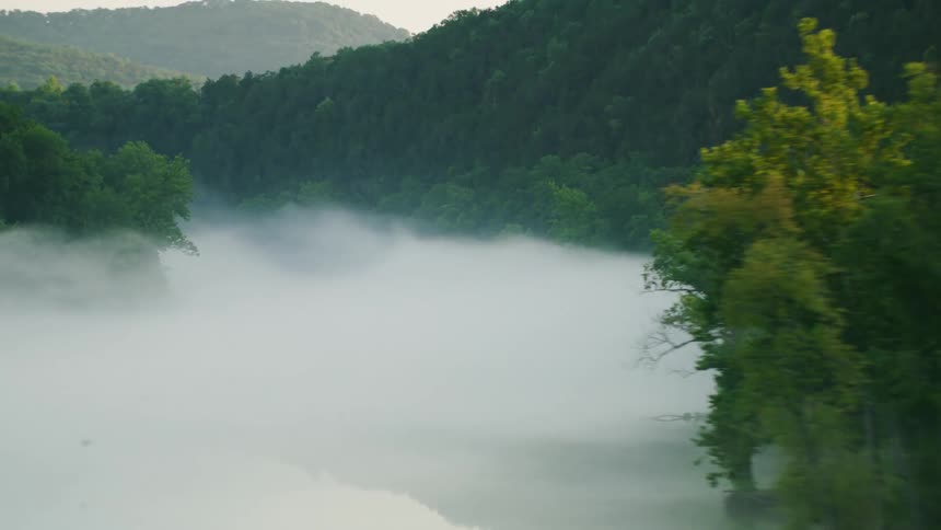 Heavy fog floats on the mountain top