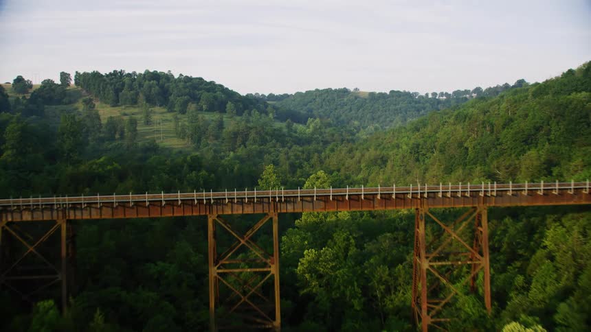 A bridge spans a mountain valley
