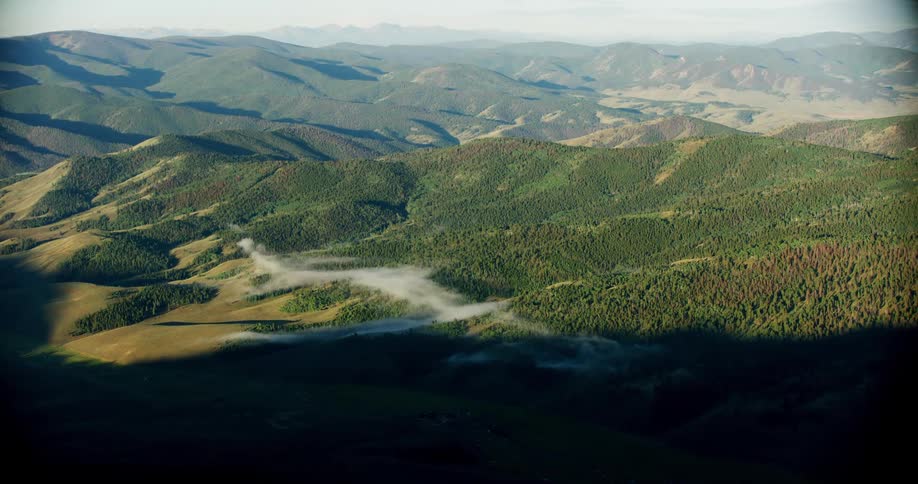 Aerial panorama of greenish mountain ranges with vegetation during daytime