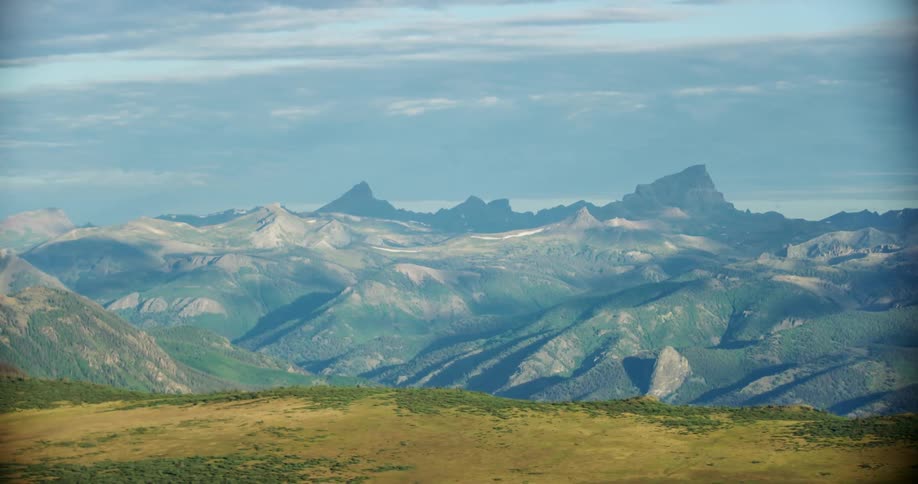The peaks of a vast mountain range at daytime