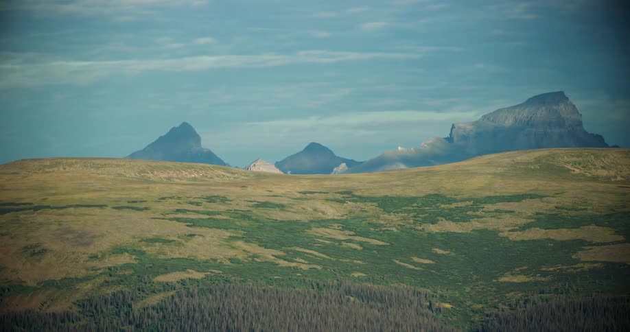 Aerial panorama of hills and mountains on a blue sky day with clouds