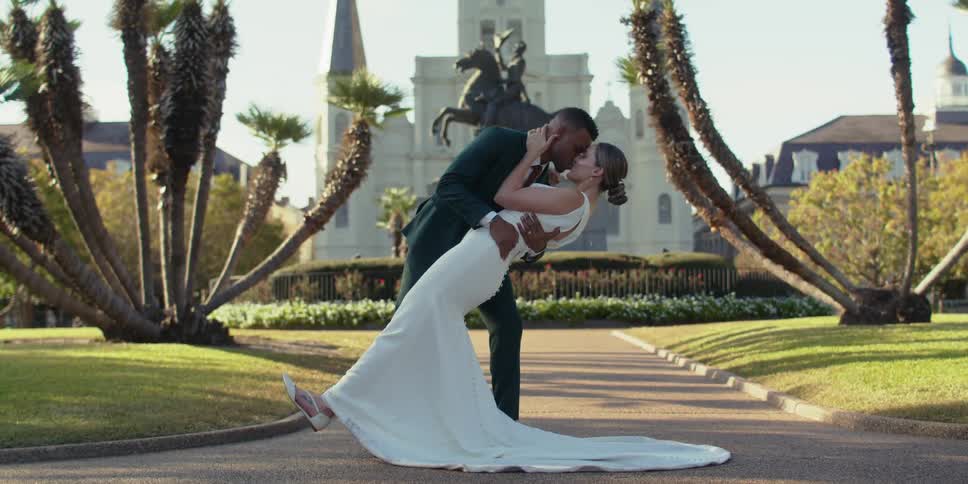 A bride and groom share a kiss outdoors