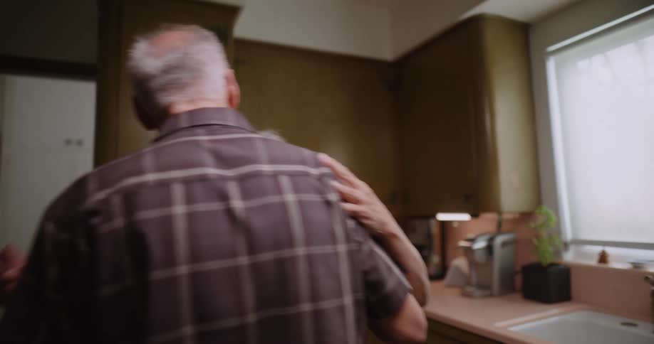 Man washing the dishes and then his wife arrives and they start dancing romantically