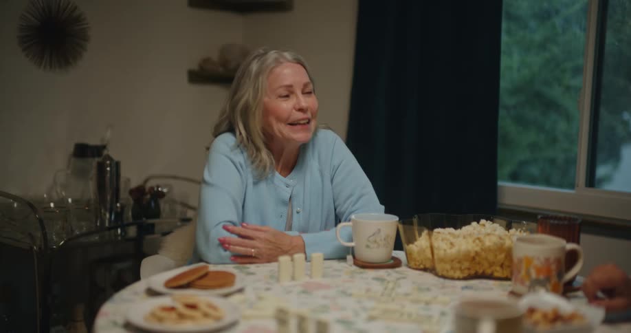 A group of elderly women playing dominoes at home
