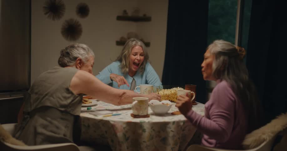 Friends sitting at a table playing dice and having fun