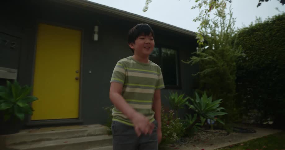 A kid follows his grandfather outdoors