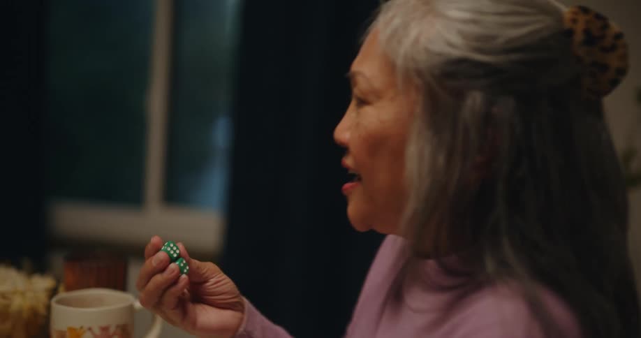 Three women play a game using dice