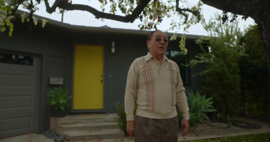 A grandfather sees his grandson riding a bicycle