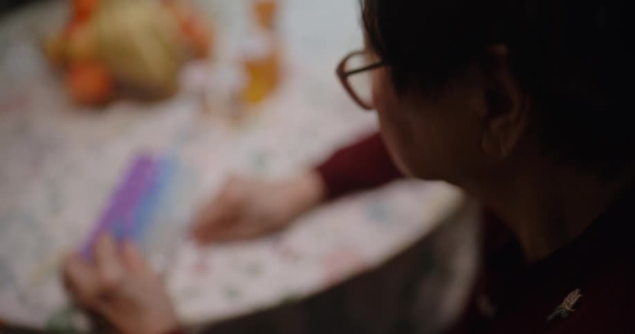 Elderly lady organizing her medicines in a separator box