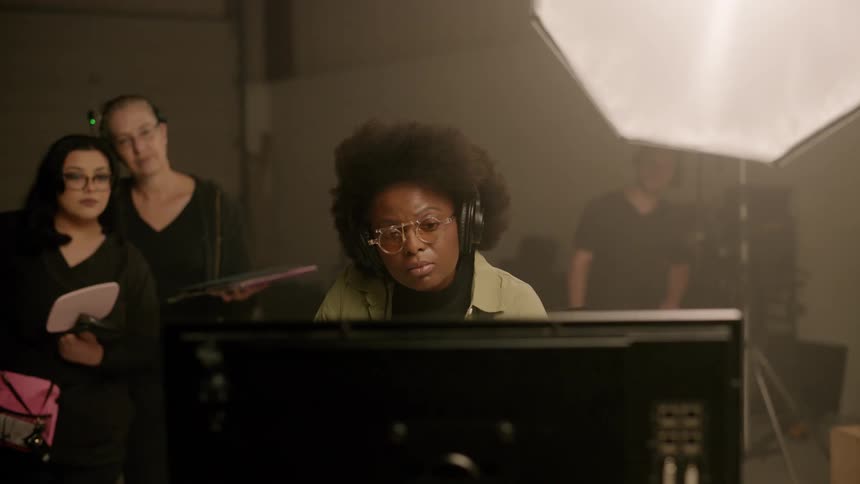 People in the recording studio concentrated watching on a monitor