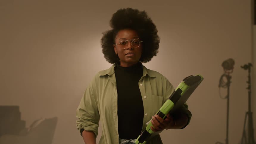 A black woman stands in a room
