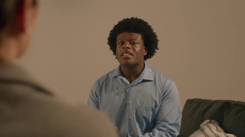 Man sitting in a studio talking to a woman