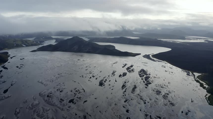 A large blue lake with several small rocky islands