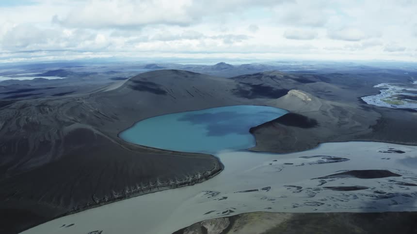 Body of water surrounded by land on a cloudy day