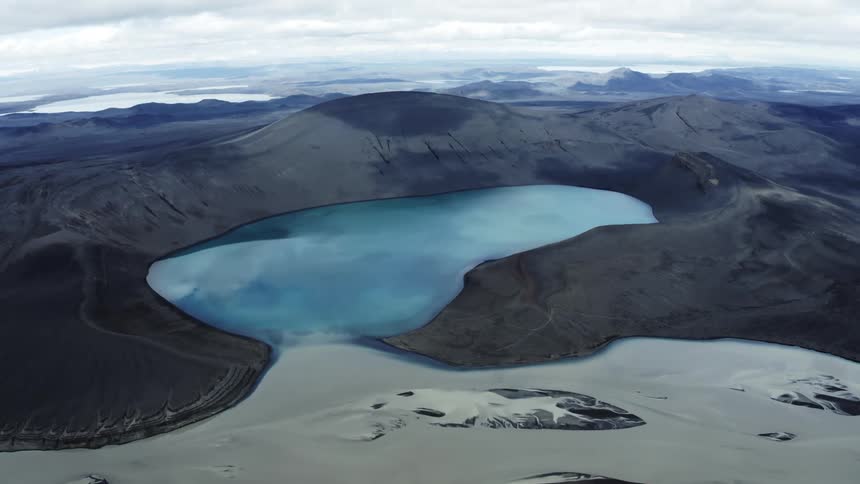Snow in the arctic landscape is melting into a body of water