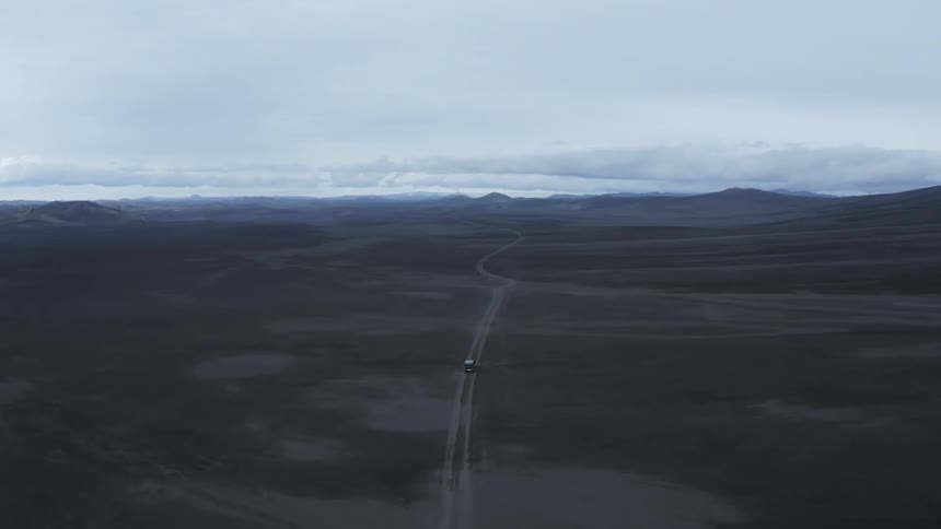 Vehicle traveling on a dirty road near the mountains