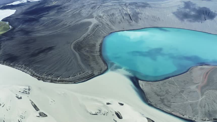 Aerial view of bright blue lake in a glacial crater
