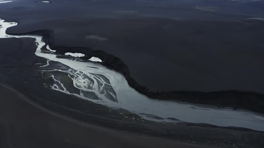 A river wends through a flat area