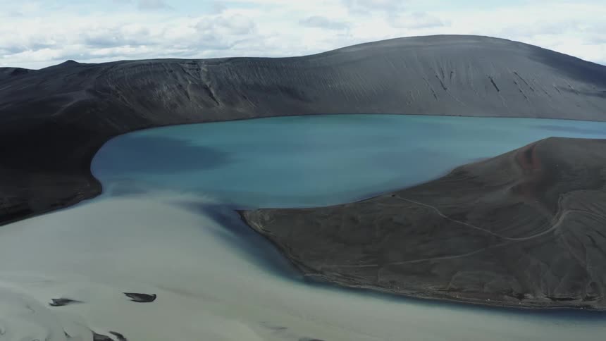 Blue lake crater surrounded by land formation