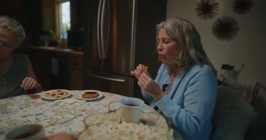 Three women have fun around a kitchen table