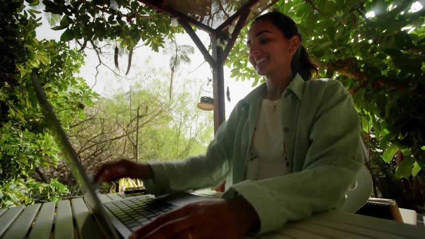 An indian woman opens a laptop
