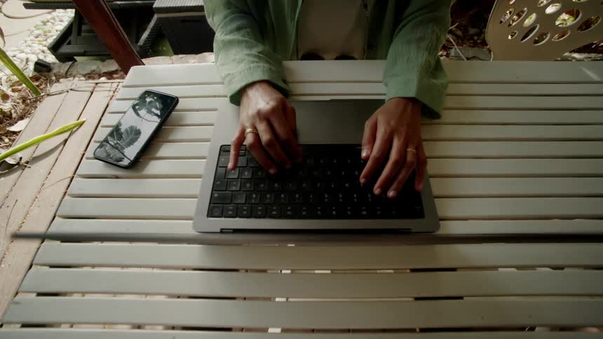 Woman working on a laptop in the garden