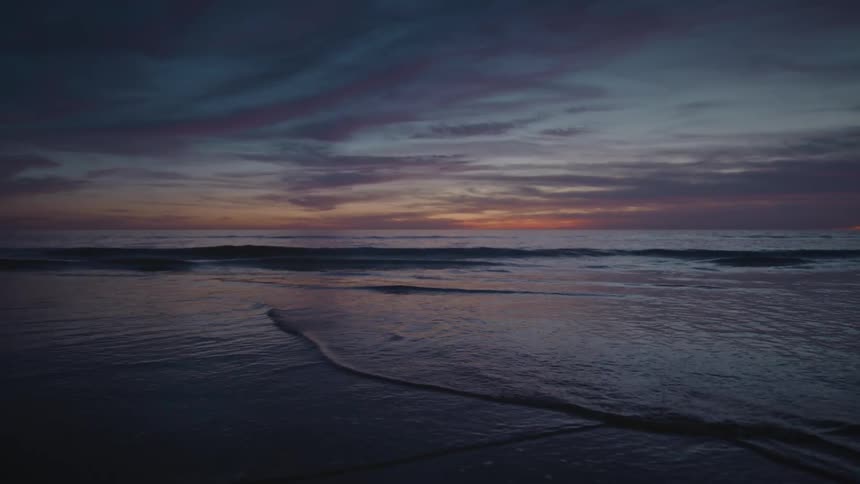 The tide comes in on a beach