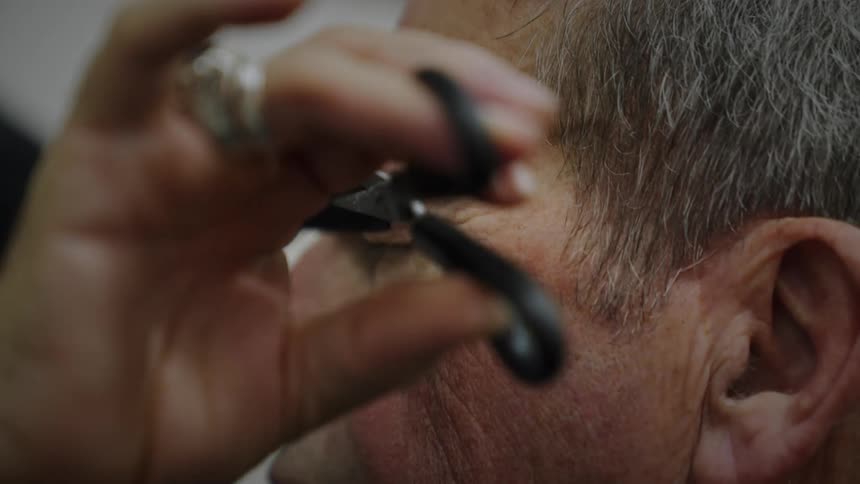 Close up of a man getting his eyebrows styled