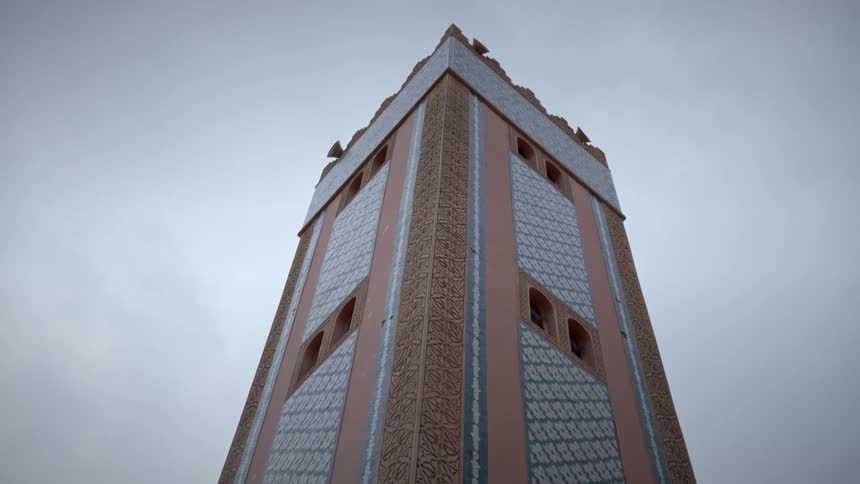 Exterior architecture of a tower in a cloudy court