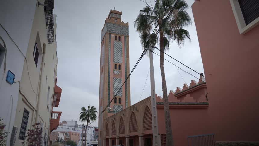 Exterior shot of a mosque with other buildings visible