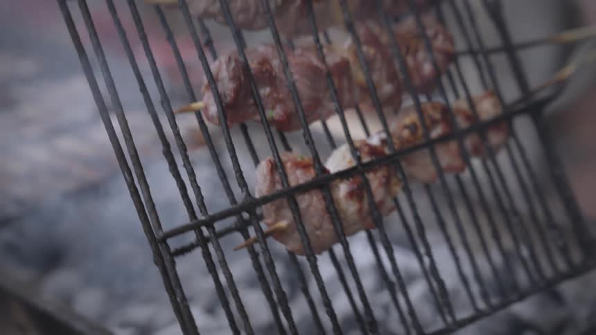 A clip of a person making a meat barbecue