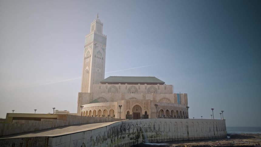 Temple with a large tower by the sea on a blue sky day