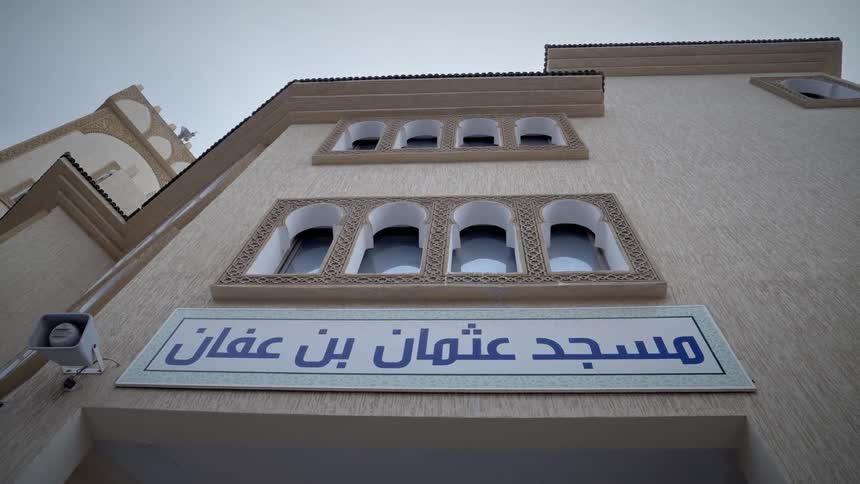 Exterior architecture of the facade of a building with an arabic written sign