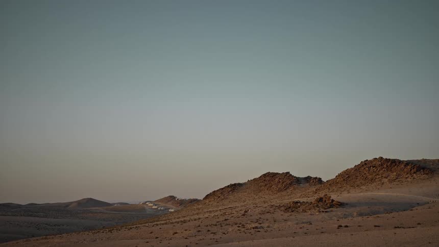 Sun is setting in the horizon of the desert landscape
