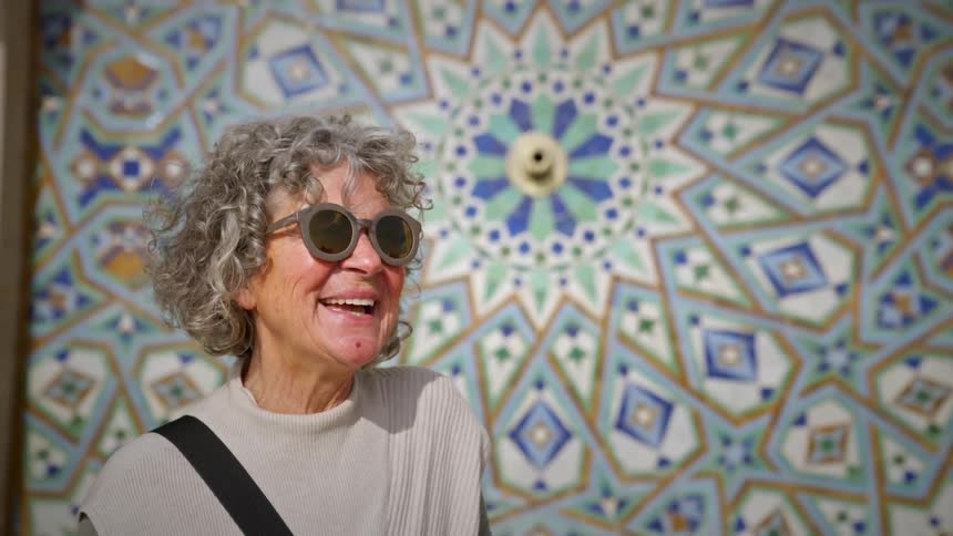 Portrait of a woman with sunglasses outdoors smiling