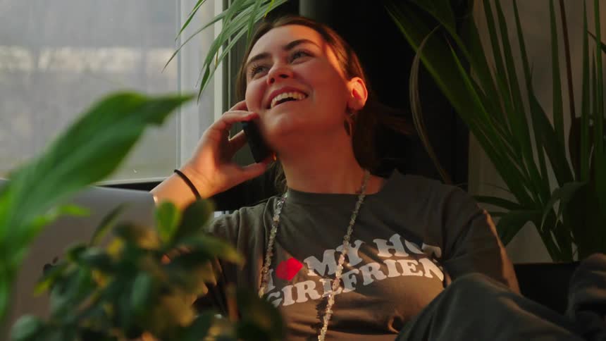 Woman talking on the phone indoors