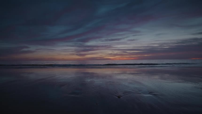 Sun is setting in the horizon of the sandy beach