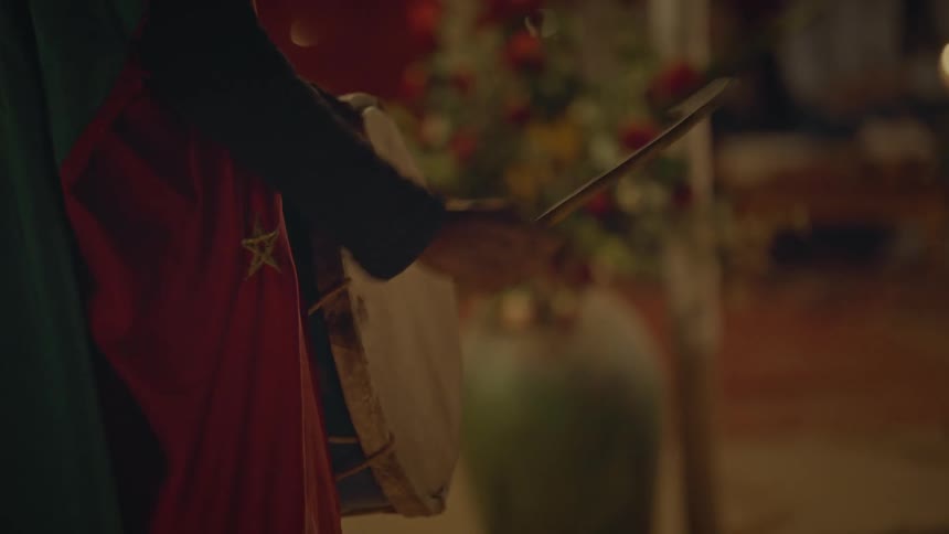 Closeup of a person playing drums on a temple