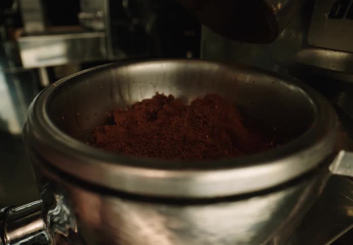 Filling the portafilter of an espresso machine with ground coffee