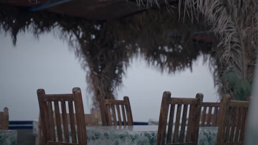 There is an outdoor dining area with an empty table