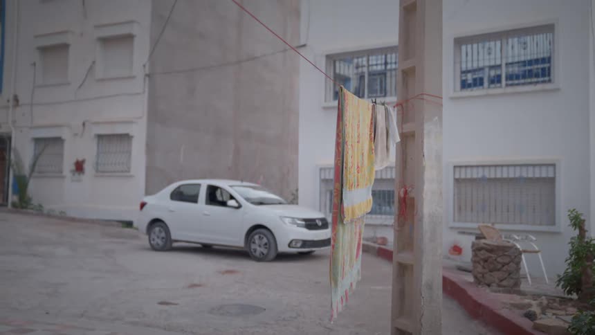 White sedan car parked on the street in a residential neighborhood